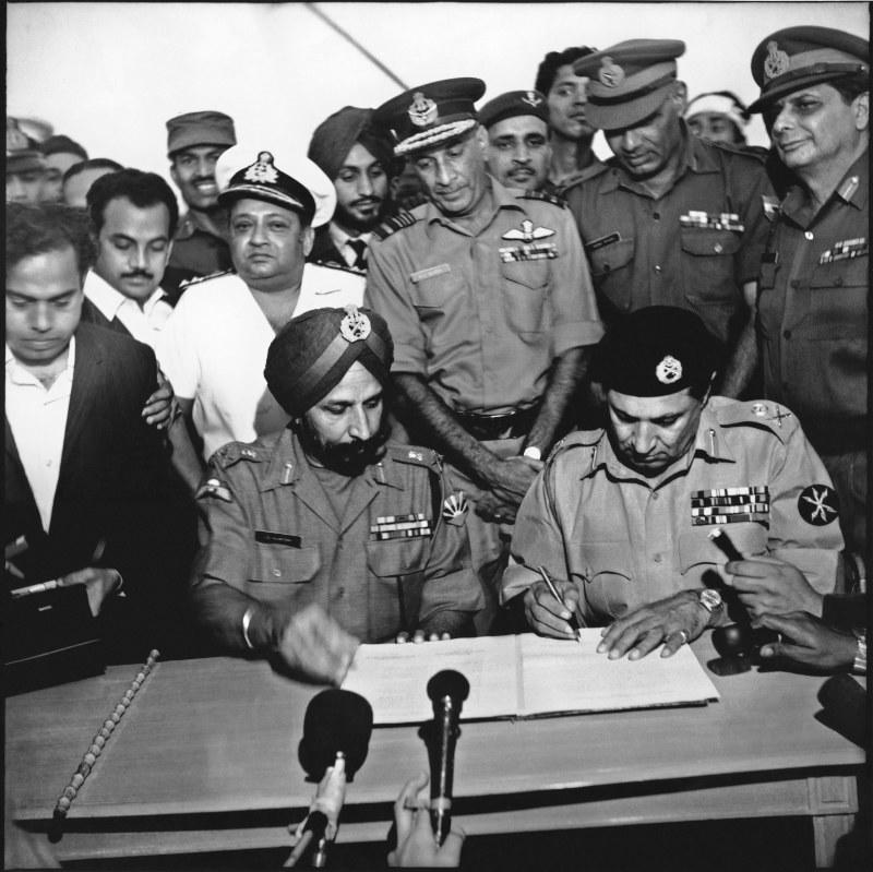 General Niazi of the occupation forces was the first to sign the document of surrender, sitting beside him was General Aurora of the Indian army. They are flanked by commander of the Bangladesh Air Force, A.K. Khondokar and Indian Army officers. Bangladesh. 16 December 1971. Credits: Aftab Ahmed/Drik/Majority World